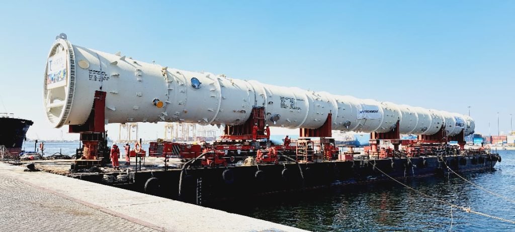 Large splitter column being hauled by trailer