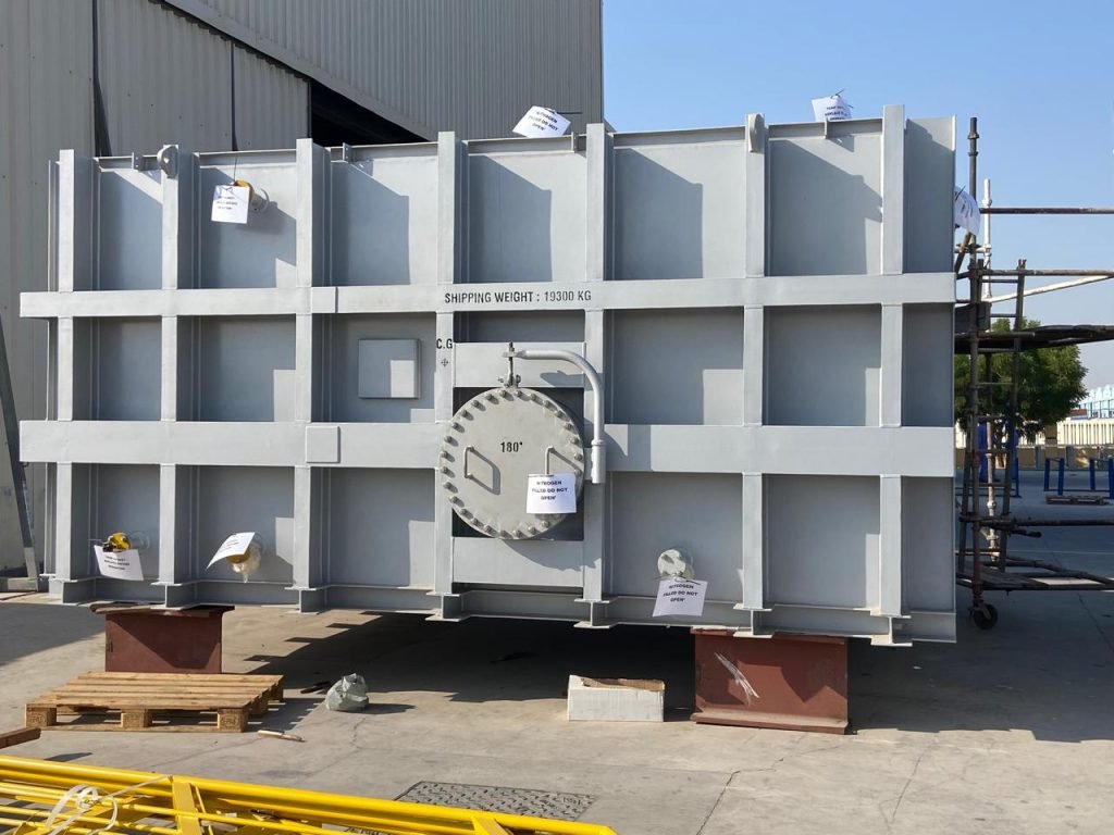 Welders inspecting exchanger assembly