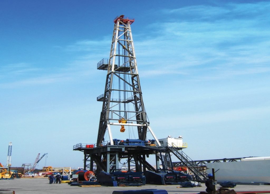 Black oil rig under clear sky