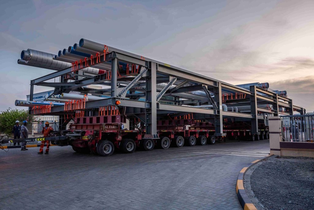 Steel skid loaded on multi-axle trailer