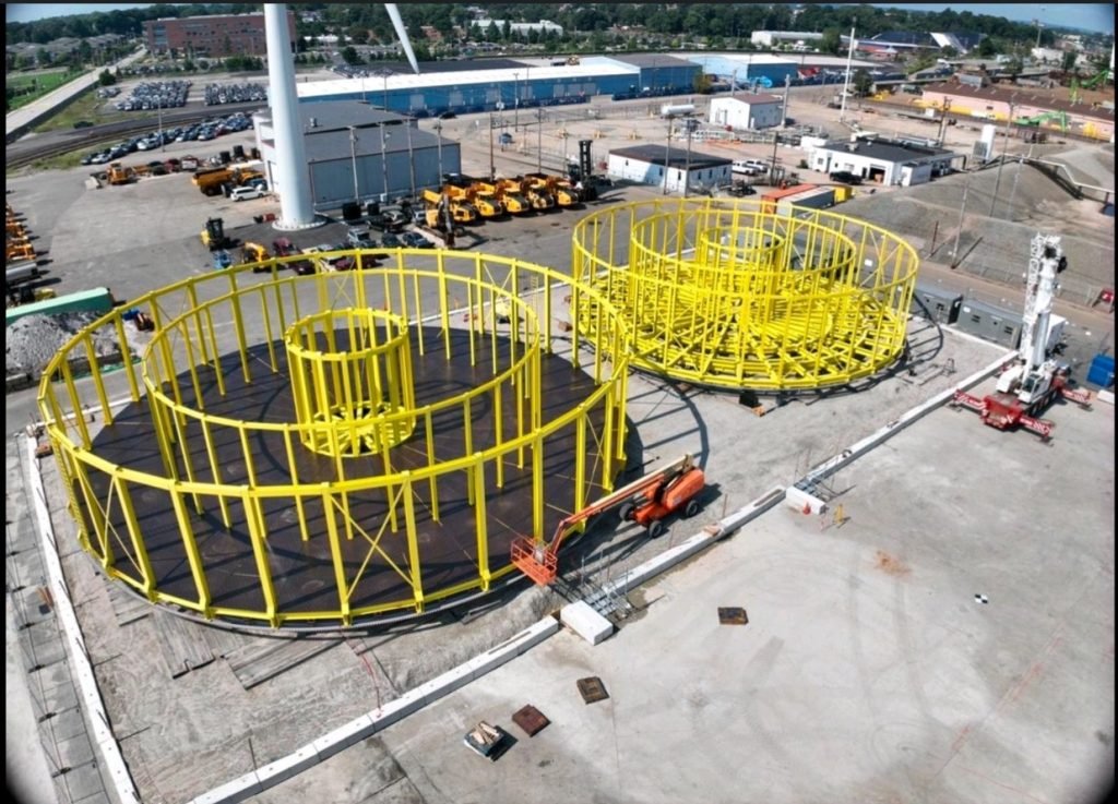 Yellow offshore carousel under construction at fabrication yard.