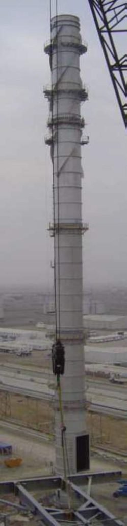 Tall chimney under fog