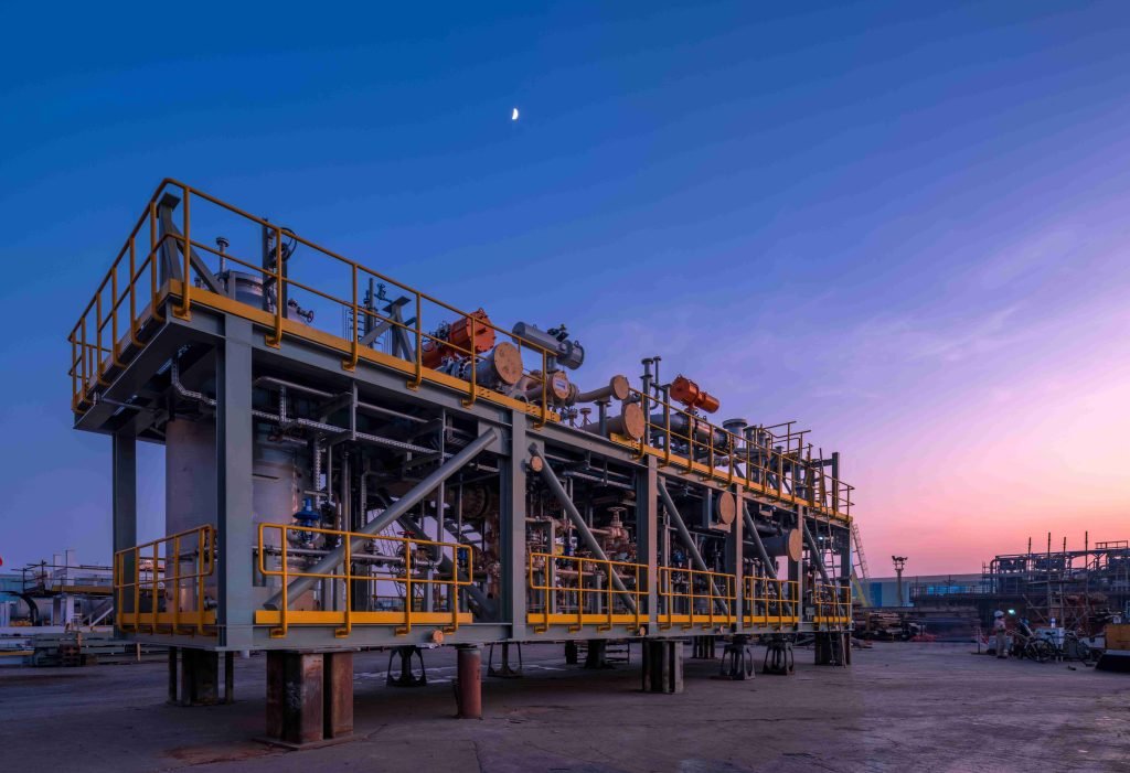 Industrial piping skid at sunset