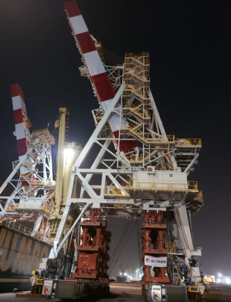 Night-lit oil rig crane