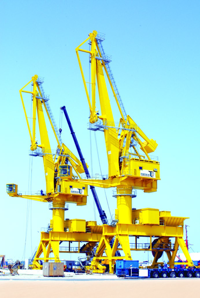 Yellow dock cranes in blue sky