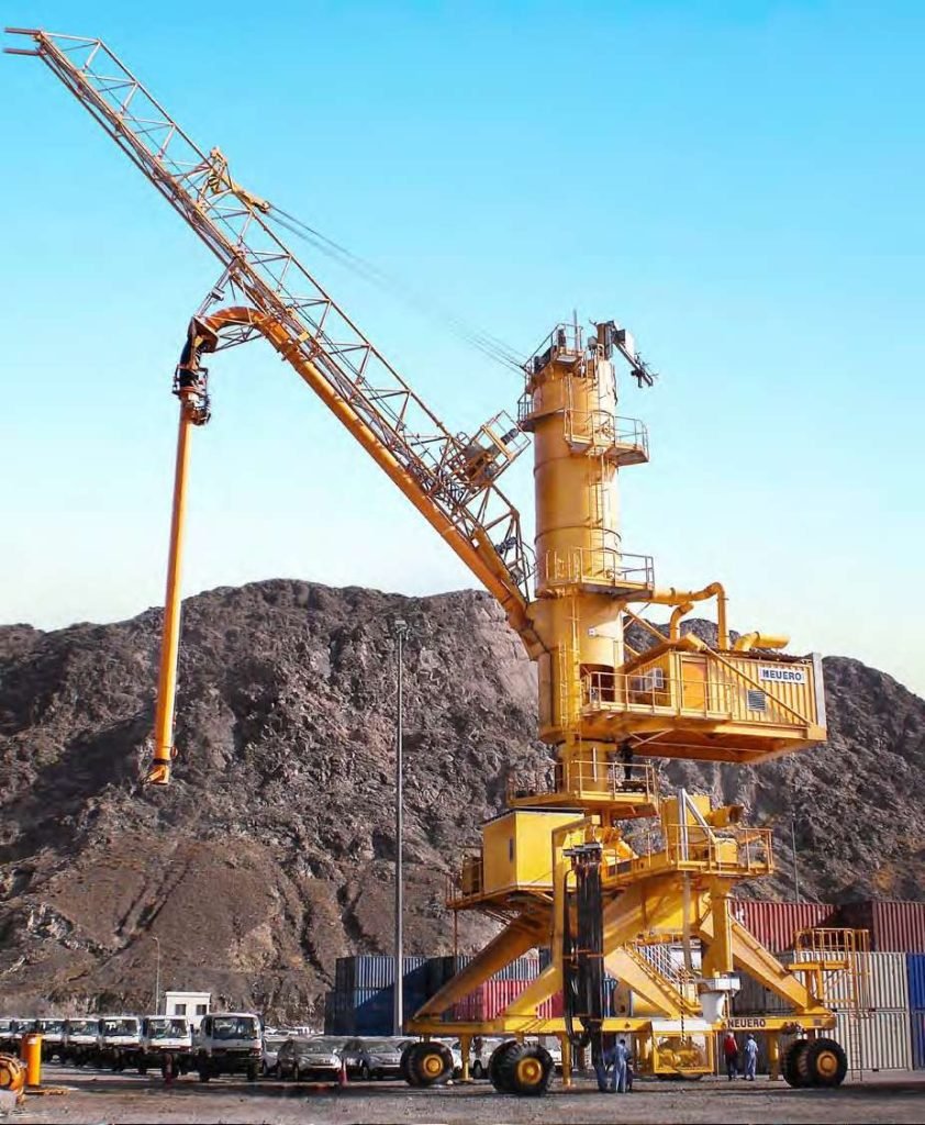 Yellow crane unloading rocks